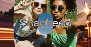 Two women wearing sunglasses pose for a selfie outdoors on grass, one making a peace sign. The word "Snapseed" is overlaid on the image with a sky and grass graphic inside the letters.